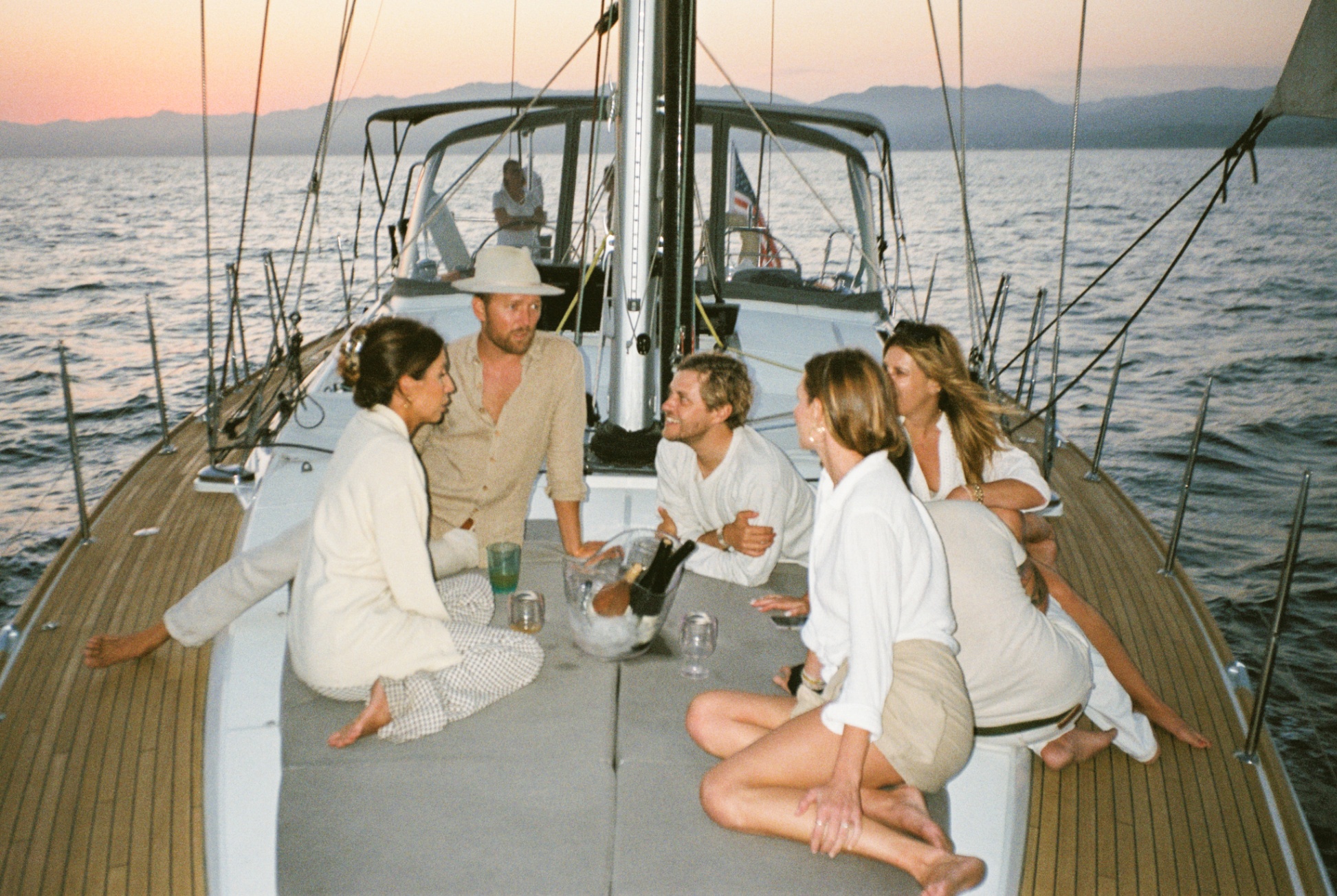 Friends celebrating on a luxury yacht with champagne